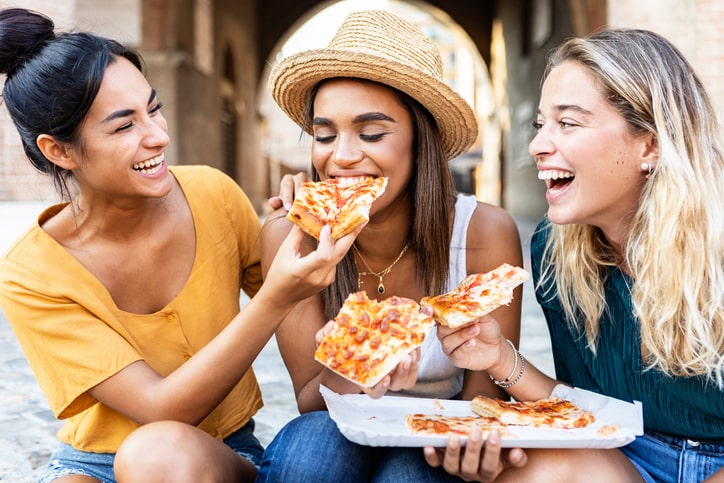 Girls munching on pizza