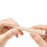 Hand holding a thin, beige object with 'Ethereal' branding on a white background